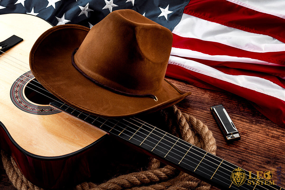 Guitar and hat on the background of the American flag