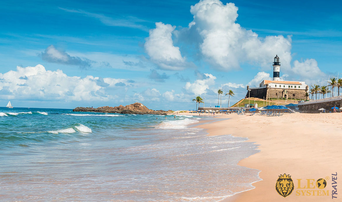 View of the beach and Farol da Barra in the city of Salvador, Brazil