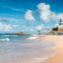 View of the beach and Farol da Barra in the city of Salvador, Brazil