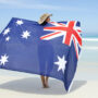 Image of a woman on the beach with the Australian flag in her hands