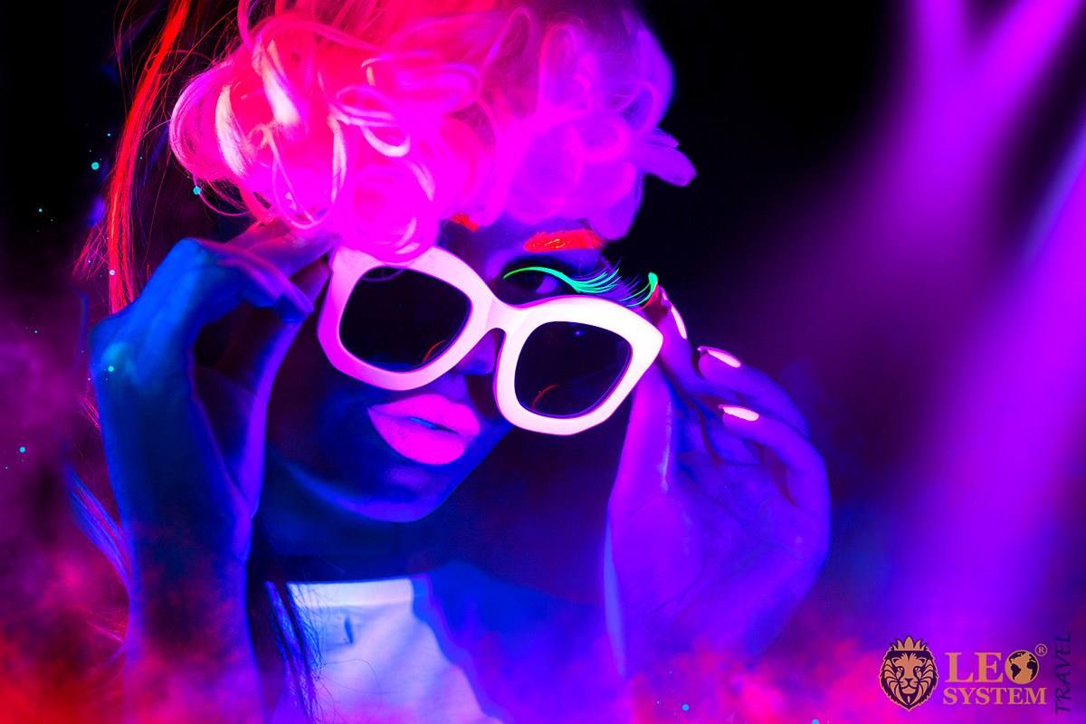 Image of a girl with glasses in neon colors