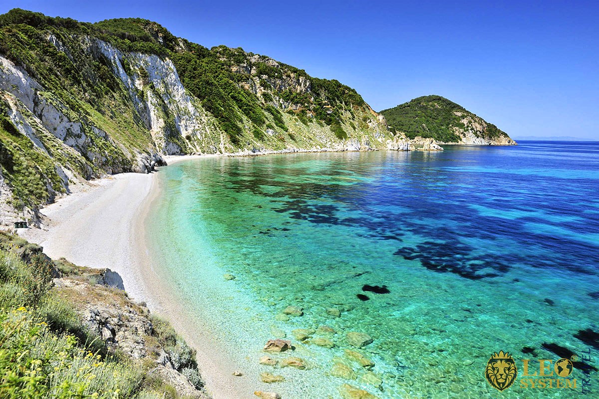 Beautiful view of the beach at the foot of the mountains on the island of Elba in Italy